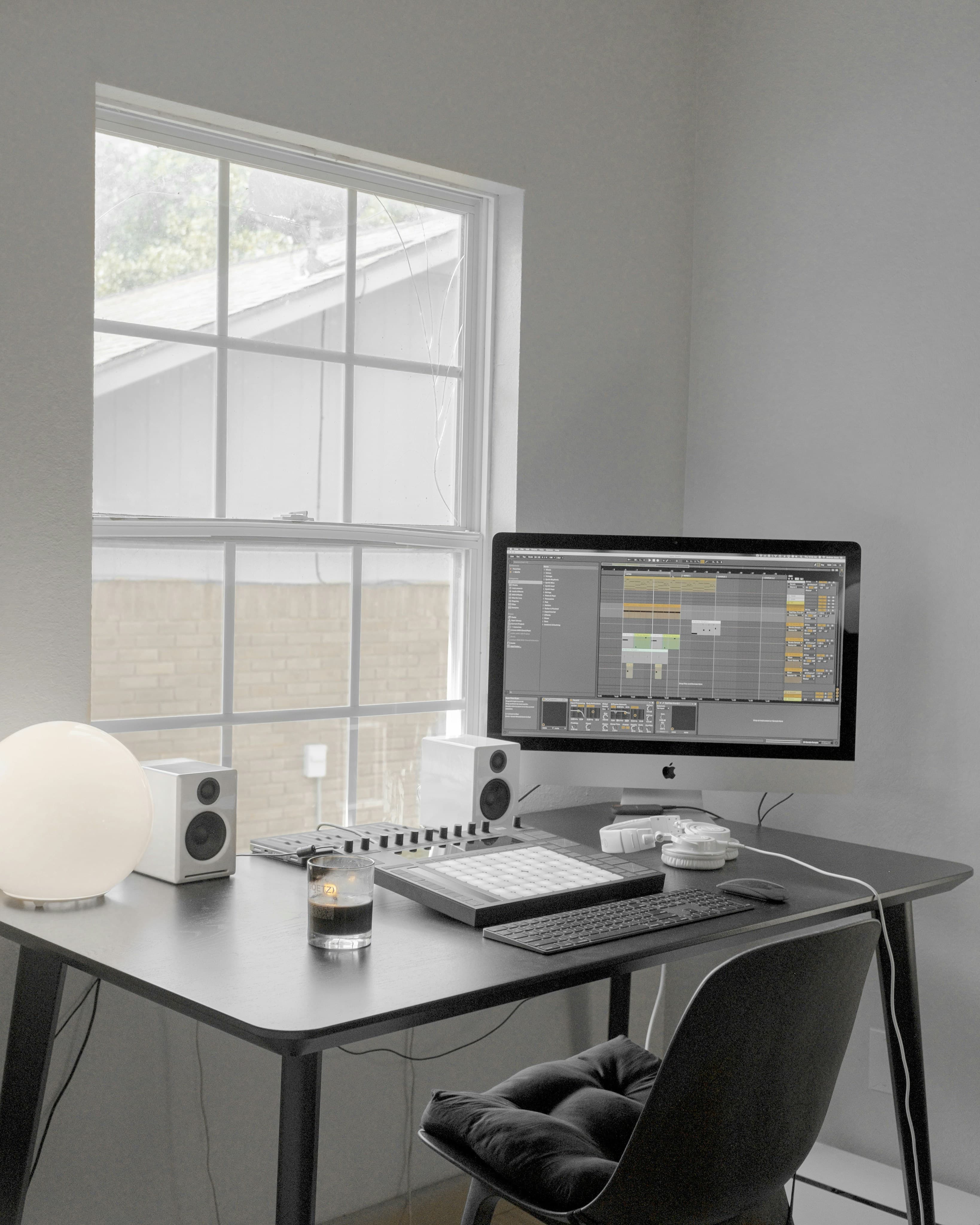 Small home office desk beside a sash window