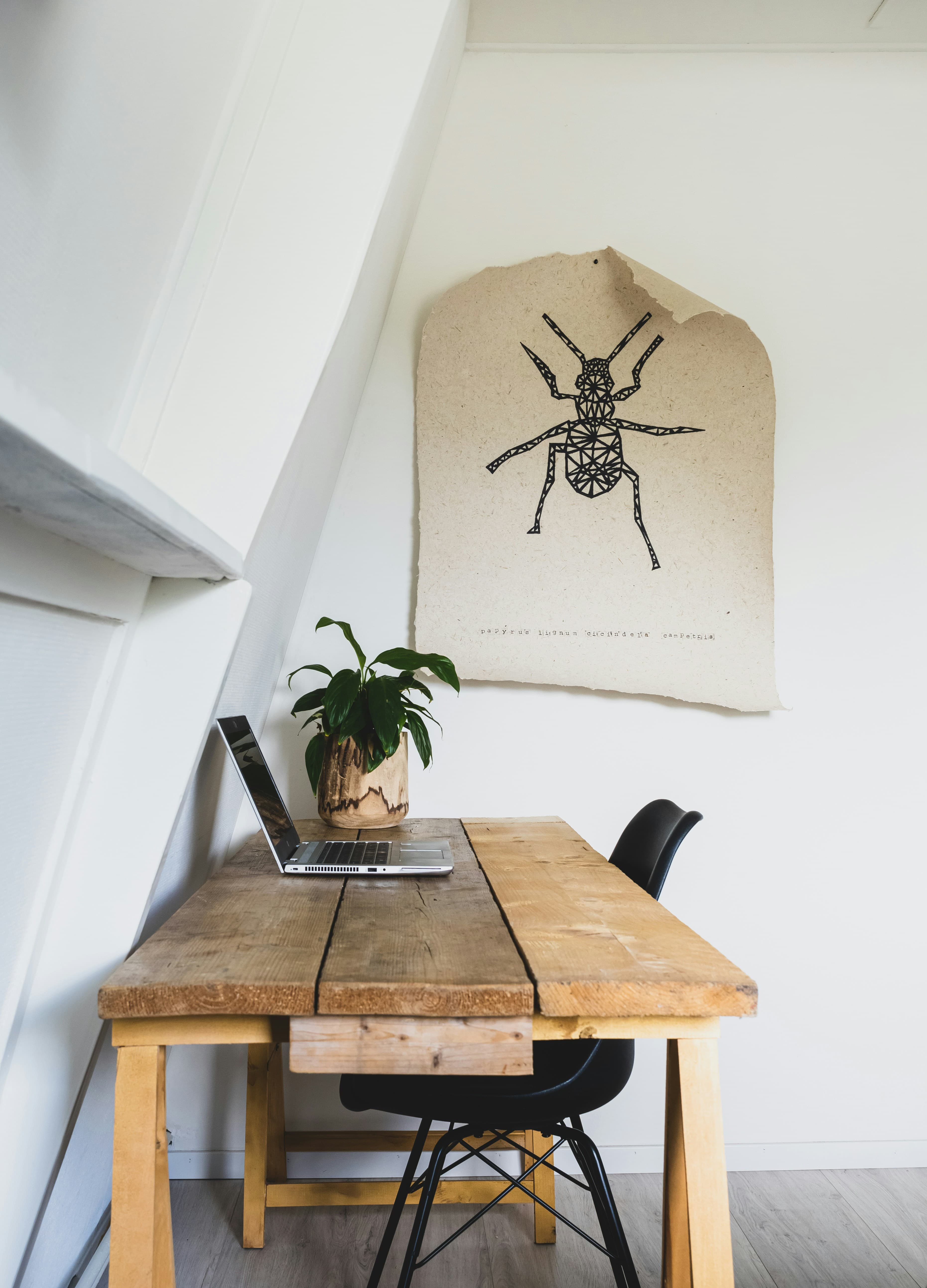 Converted room used as a home office, under a sloped ceiling